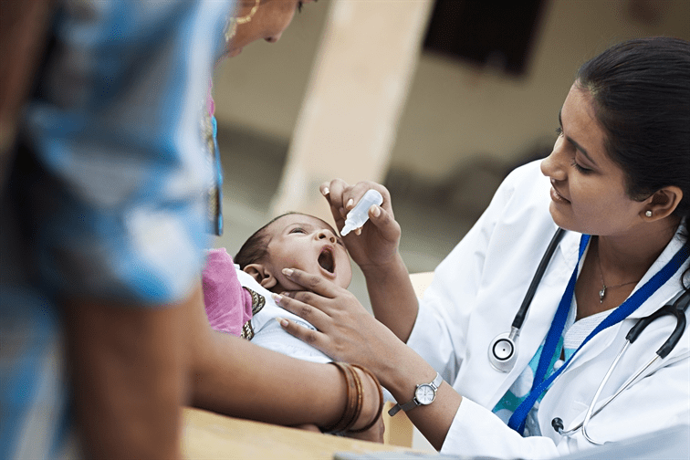 doctor gives polio drops